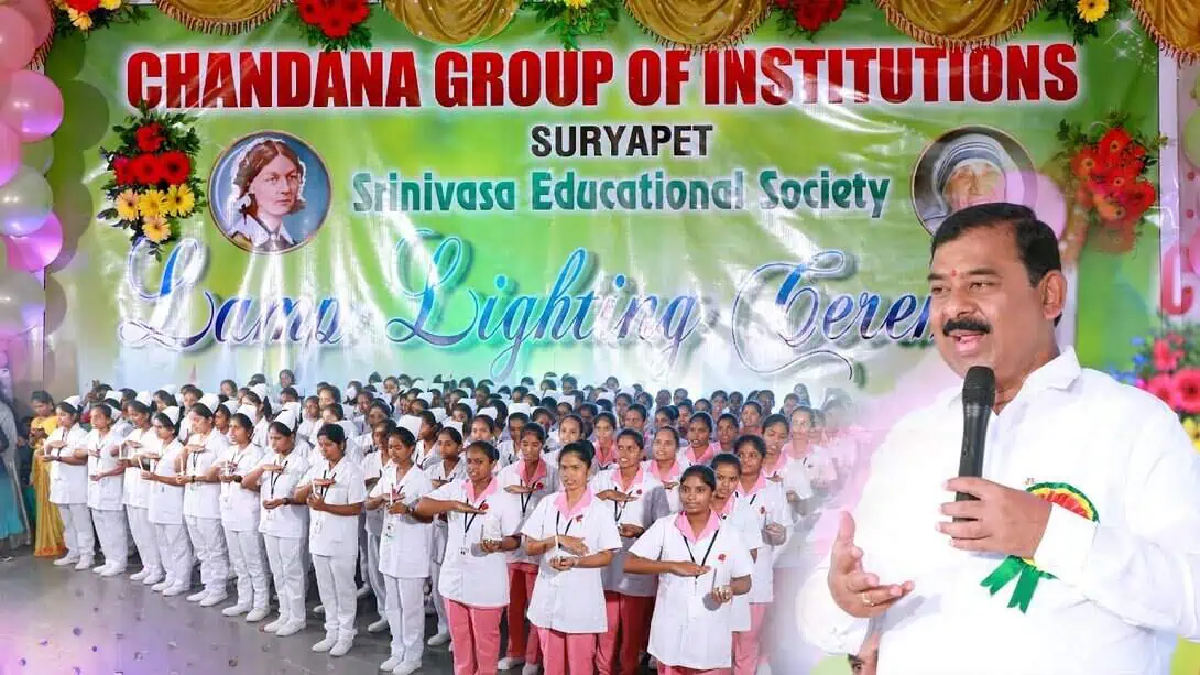 Nursing students participating in lamp lighting ceremony at Chandana Group of Institutions, Suryapet with faculty and large student gathering